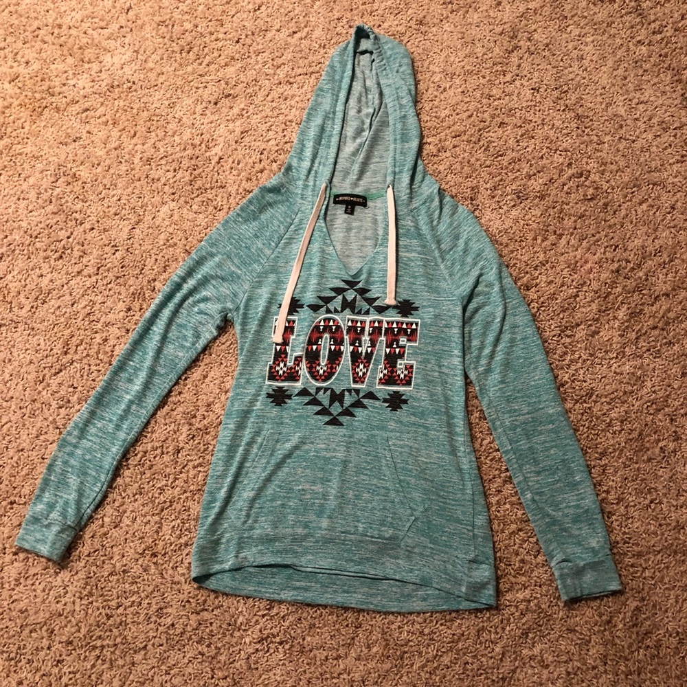 A teal/blue colored sweatshirt that says Love